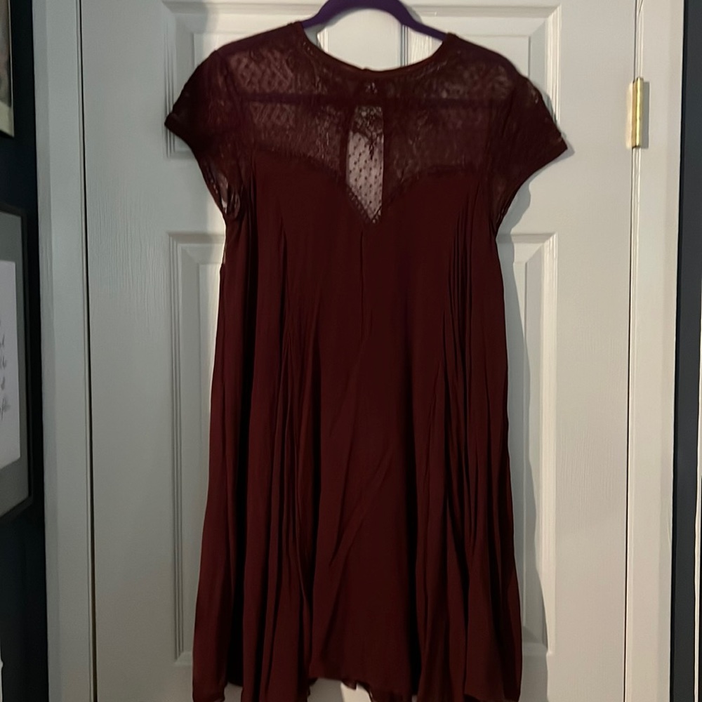 Maroon dress with lace pattern at the top and sleeves. In a size large.